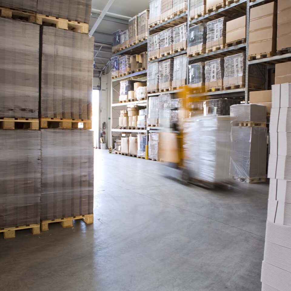 Blurred forklift truck in storage warehouse
